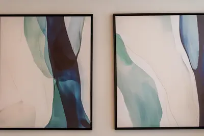 two framed pictures on a wall at TRPS - Imperial Avenue, Downtown - Burj Khalifa View, Brand New, Amazing Facilities in Dubai