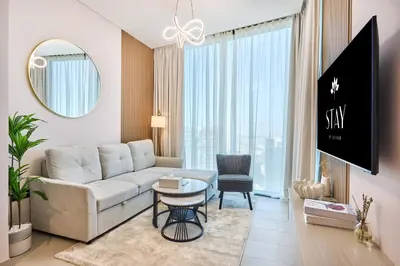a living room with a couch and a table at STAY BY LATINEM Luxury 1BR Holiday Home W 2809 Near Burj Khalifa in Dubai