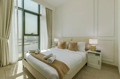 a bedroom with a large bed with a large window at Fawad Azizi Residence, Al Jaddaf- 1BR - Allsopp & Allsopp in Dubai