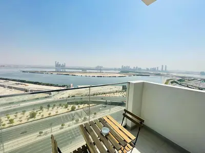 a balcony with a bench and a view of the water at Fawad Azizi Residence, Al Jaddaf- 1BR - Allsopp & Allsopp in Dubai
