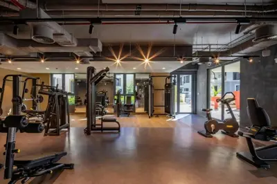 a gym with treadmills and exercise equipment in a building at Coastal Haven 1BDR in La Cote B4-12 in Dubai
