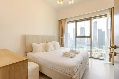 a bedroom with a large bed with a large window at Full Burj Khalifa View, 3min Walk to Dubai Mall, 29th floor in Dubai