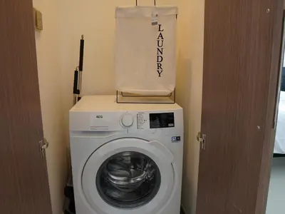 a washing machine with a bag on top of it at Full Burj Khalifa View, 3min Walk to Dubai Mall, 29th floor in Dubai