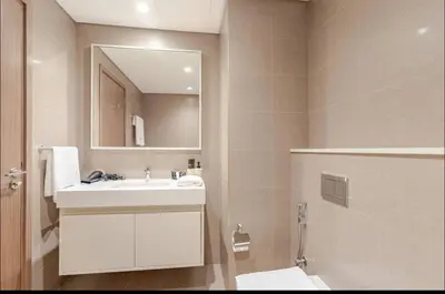 a bathroom with a white sink and a mirror at Full Burj Khalifa View, 3min Walk to Dubai Mall, 29th floor in Dubai