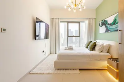 a bedroom with a bed and a large window at Full Burj Khalifa View, 3min Walk to Dubai Mall, 29th floor in Dubai