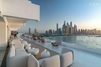 a building with white chairs and a view of a city at FIVE Palm Jumeirah 3BR plus Luxury Lifestyle Residence in Dubai