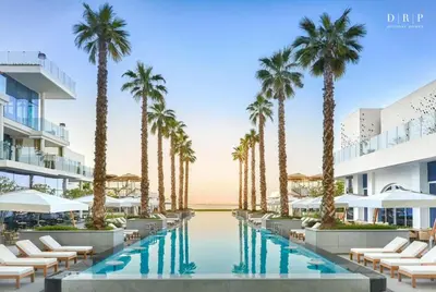 an image of a resort pool with palm trees at FIVE Palm Jumeirah 3BR plus Luxury Lifestyle Residence in Dubai