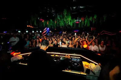 a crowd of people watching a dj in a concert at FIVE Palm Jumeirah 3BR plus Luxury Lifestyle Residence in Dubai