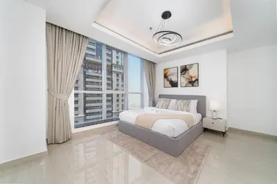 a bedroom with a bed and a large window at High-Floor Upgraded 3-Bed Marina Apartment in Dubai