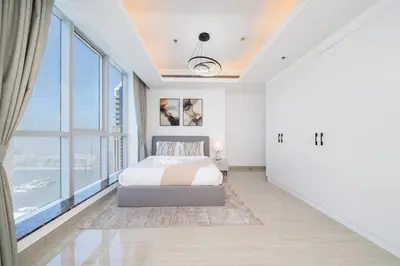 a bedroom with a bed and a large window at High-Floor Upgraded 3-Bed Marina Apartment in Dubai
