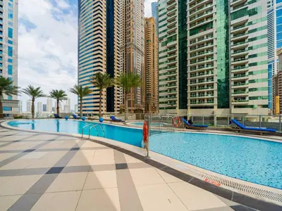 a swimming pool in a city with tall buildings at High-Floor Upgraded 3-Bed Marina Apartment in Dubai