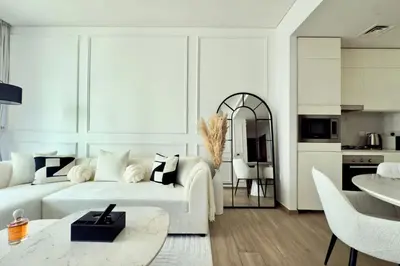 a living room with a white couch and a table at Luxury 1 Bed Apt in Palace, Dubai Creek Harbour in Dubai