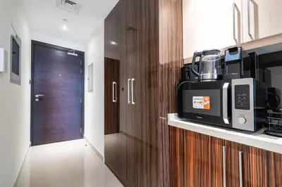 a kitchen with a microwave on top of a counter at Stylish and Spacious Downtown Studio in Dubai