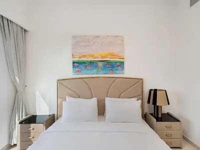 a bedroom with a bed and a painting on the wall at Iconic Burj and Fountain View 2BR Downtown in Dubai