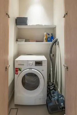 a washing machine in a small room with a door at New 2BR Luxe Vida Dubai Mall Direct Access in Dubai