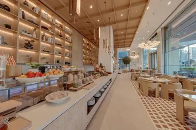 a restaurant with a counter with food on it at New 2BR Luxe Vida Dubai Mall Direct Access in Dubai