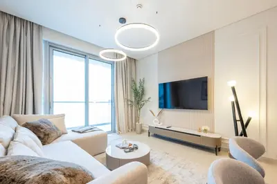 a living room with a white couch and a tv at New 2BR Luxe Vida Dubai Mall Direct Access in Dubai