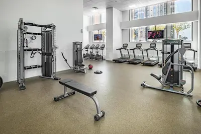 a gym with several exercise bikes and treadmills at Luxury Leisure Massive Pool Oasis in Amna Tower in Dubai