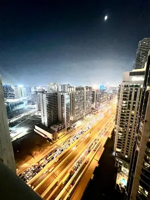a view of a city at night with traffic at Spacious Modern High Floor Independent Studio Downtown in Dubai