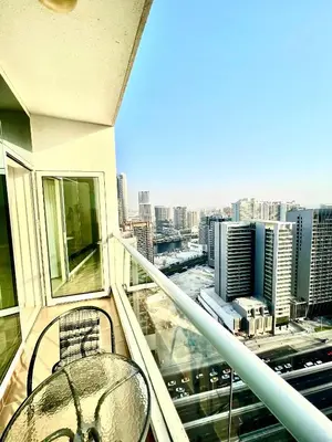a balcony with a table and a view of a city at Spacious Modern High Floor Independent Studio Downtown in Dubai