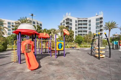 a playground with several slides and slidesktop at Brand New Designer Space with All Modern Amenities in Dubai