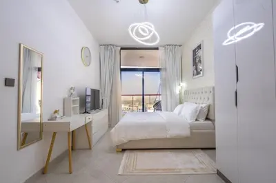 a bedroom with a bed and a desk and a window at Luxury 1 Bedroom with Pool Dubai Frame Museum View in Dubai