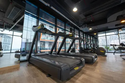 a gym with rows of treadmills and elliptical machines at Luxury 1 Bedroom with Pool Dubai Frame Museum View in Dubai