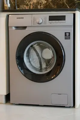 a washing machine is sitting in a kitchen at Luxury 1 Bedroom with Pool Dubai Frame Museum View in Dubai