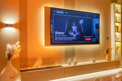 a television in a living room with a fireplace at Luxury 2BHK in DownTown with Burj Khalifa View Imperial 2415 in Dubai