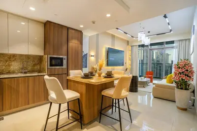 a living room with a kitchen with a table and chairs at Luxury 2BHK in DownTown with Burj Khalifa View Imperial 2415 in Dubai