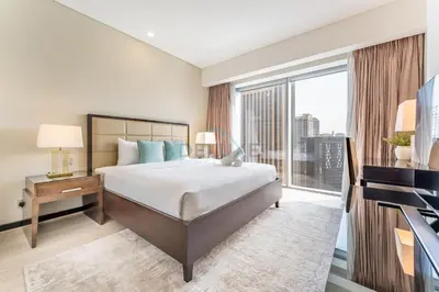 a bedroom with a bed and a large window at Panoramic Dubai Water Canal Views 1BR with Seamless Access to Marina Mall, Steps from the Tram, The Address Residences, Dubai Marina by Deluxe Holiday Homes in Dubai