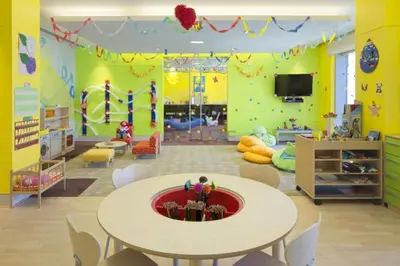 a childrens room with a table and a play area at Panoramic Dubai Water Canal Views 1BR with Seamless Access to Marina Mall, Steps from the Tram, The Address Residences, Dubai Marina by Deluxe Holiday Homes in Dubai