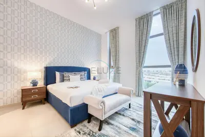 a bedroom with a blue bed and a desk and a chair at Fresh 2BR at Mudon Views 4, Dubailand by Deluxe Holiday Homes in Dubai