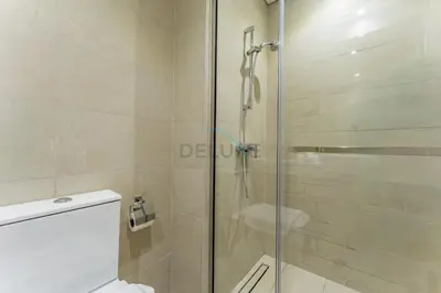 a bathroom with a glass shower with a toilet at Studio Near Meydan Racecourse and Golf Club with Convenient Access to Al Meydan Road and Dubai Top Attractions, Azizi Riviera 29, Al Merkadh by Deluxe Holiday Homes in Dubai