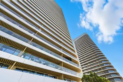 two tall buildings with a blue sky in the background at Newly Styled 1BD in Grand Bleu Beachfront, Fits 4 in Dubai