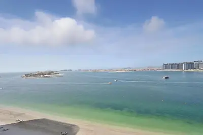 a view of a beach with boats in the water at Newly Styled 1BD in Grand Bleu Beachfront, Fits 4 in Dubai
