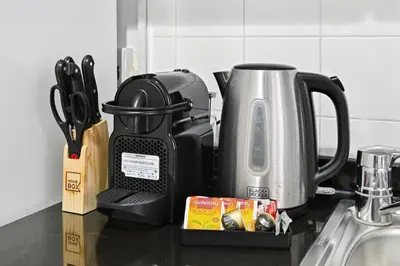 a kitchen counter top with a tea kettle and utensils at Yacht Bay Tower 1min to Metro, Tram and 5min to Marina in Dubai