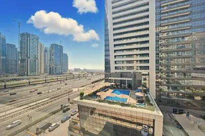 a view of a city with buildings and a highway at Yacht Bay Tower 1min to Metro, Tram and 5min to Marina in Dubai