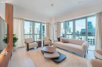 a living room with a couch and chairs and windows at Downtown Dubai- Modern upgraded 1 BR Plus Study Room with Luxury Interiors and Partial Fountain Views in Dubai