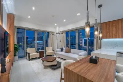 a living room with a couch and a table at Downtown Dubai- Modern upgraded 1 BR Plus Study Room with Luxury Interiors and Partial Fountain Views in Dubai