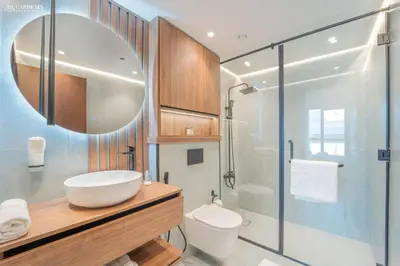 a bathroom with a sink and a glass shower at Downtown Dubai- Modern upgraded 1 BR Plus Study Room with Luxury Interiors and Partial Fountain Views in Dubai