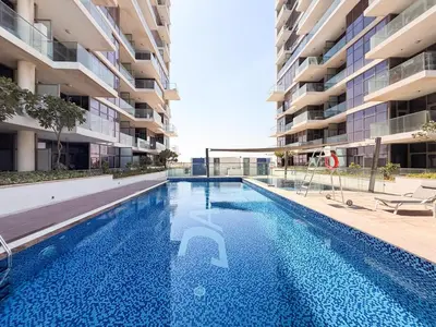 an empty swimming pool in front of a building at GuestReady - Golf View | Park Access | DAMAC Hills in Dubai