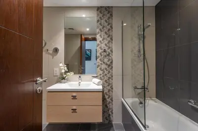 a bathroom with a sink and a tub and a shower at GuestReady - Golf View | Park Access | DAMAC Hills in Dubai