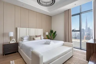 a bedroom with a large white bed and a large window at GuestReady - City 1BR | Heart of Business Bay in Dubai