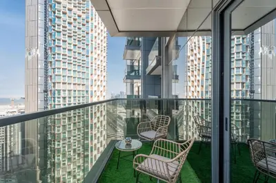 a balcony with chairs and a table and some buildings at GuestReady - City 1BR | Heart of Business Bay in Dubai