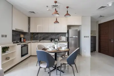a kitchen and dining room with a table and chairs at GuestReady - City 1BR | Heart of Business Bay in Dubai
