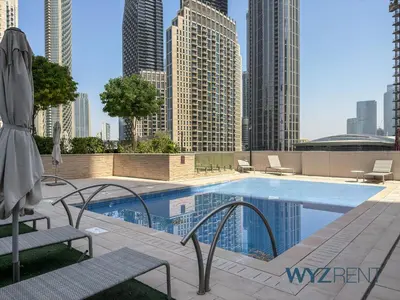 a swimming pool in a city with tall buildings at Emerald Boho Escape1BR in Forte near Burj Khalifa in Dubai