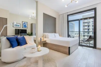 a hotel room with a bed and a couch at Urban Oasis - Modern Studio Retreat with City Views in Dubai