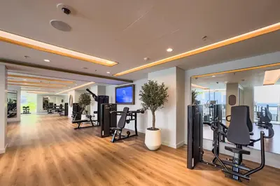 a fitness room with treadmills and exercise equipment at Prime 1 Bedroom with Private Beach in Beachfront in Dubai