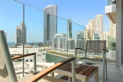 a balcony with a table and a view of a city at Silkhaus Luxury 1BR at Marina Star in Dubai Marina in Dubai
